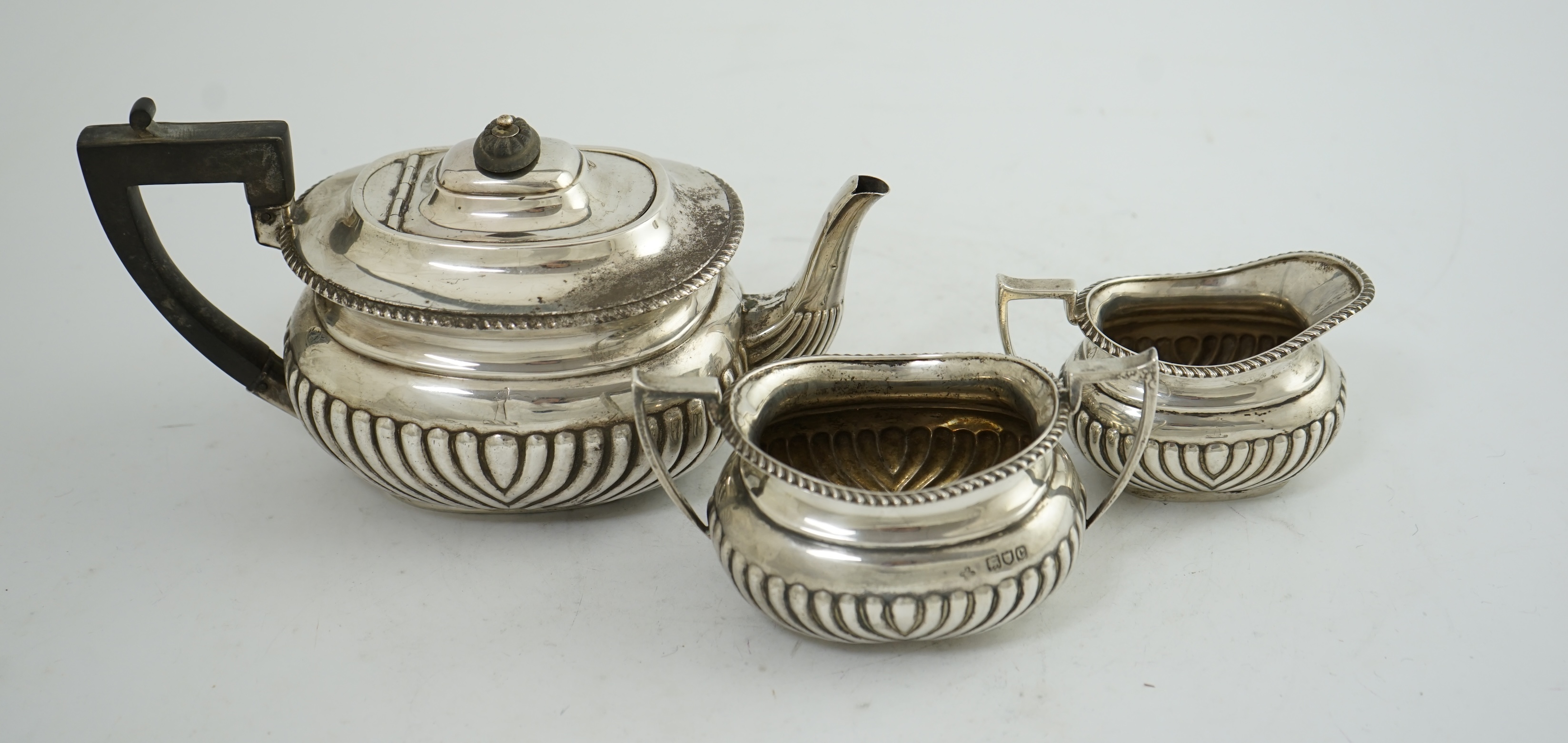 A late Victorian demi-fluted silver three piece tea set, by Horace Woodward & Co Ltd